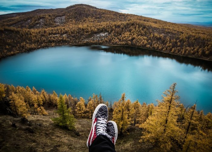Background of a lake and shoes in front